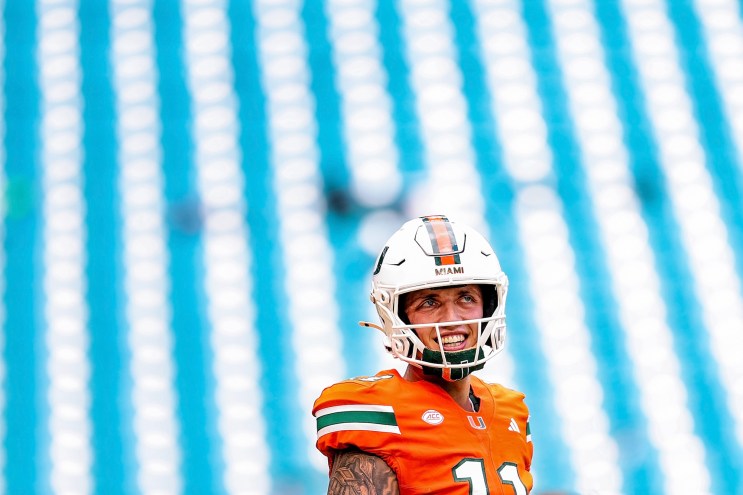 Carson Beck #11 of the Miami Hurricanes in front of a vibrant blue and white backdrop at Hard Rock Stadium n Miami Gardens, Florida, on September 13, 2025.