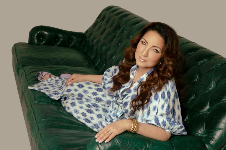 Image of a woman sitting on a green couch.