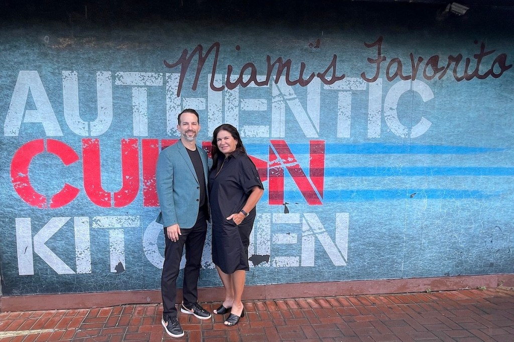 two people posing at wall