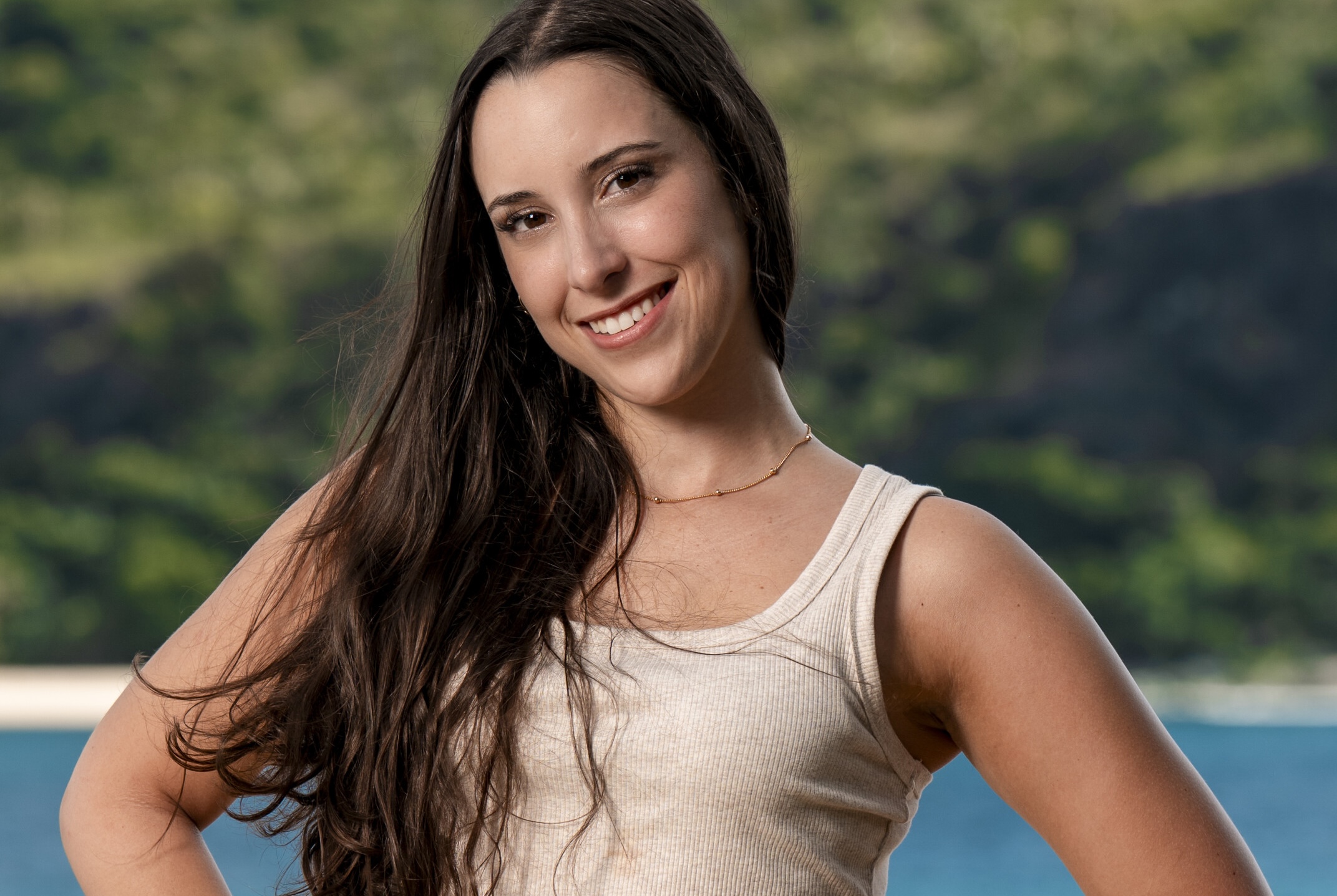 Survivor contestant Sophi Balerdi poses in front of a tropical landscape