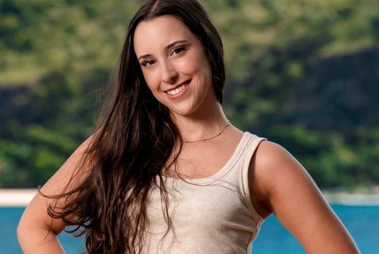 Survivor contestant Sophi Balerdi poses in front of a tropical landscape