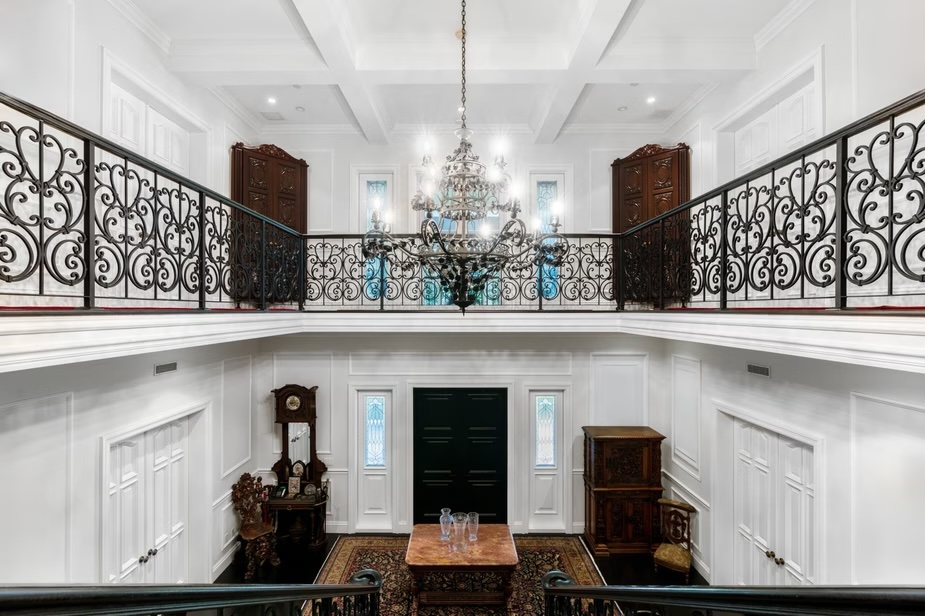 Depicted is a down-the-stairs view of the entryway.