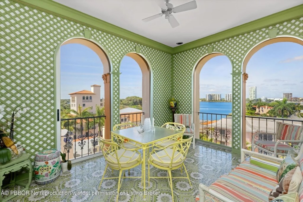 Depicted is a lime-green outdoor dining room near the roof of the penthouse tower.