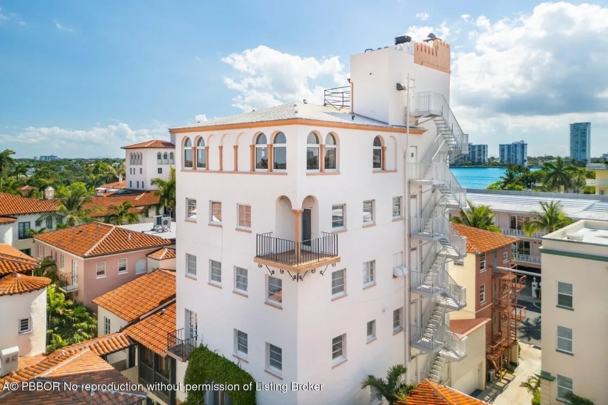 Depicted is a white, Mediterranean-inspired tower apartment in Palm Beach.