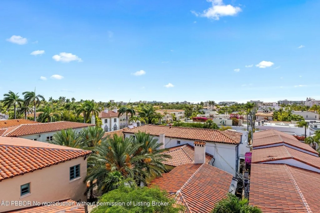 Depicted is a view from the apartment tower showing Spanish-style roofs.