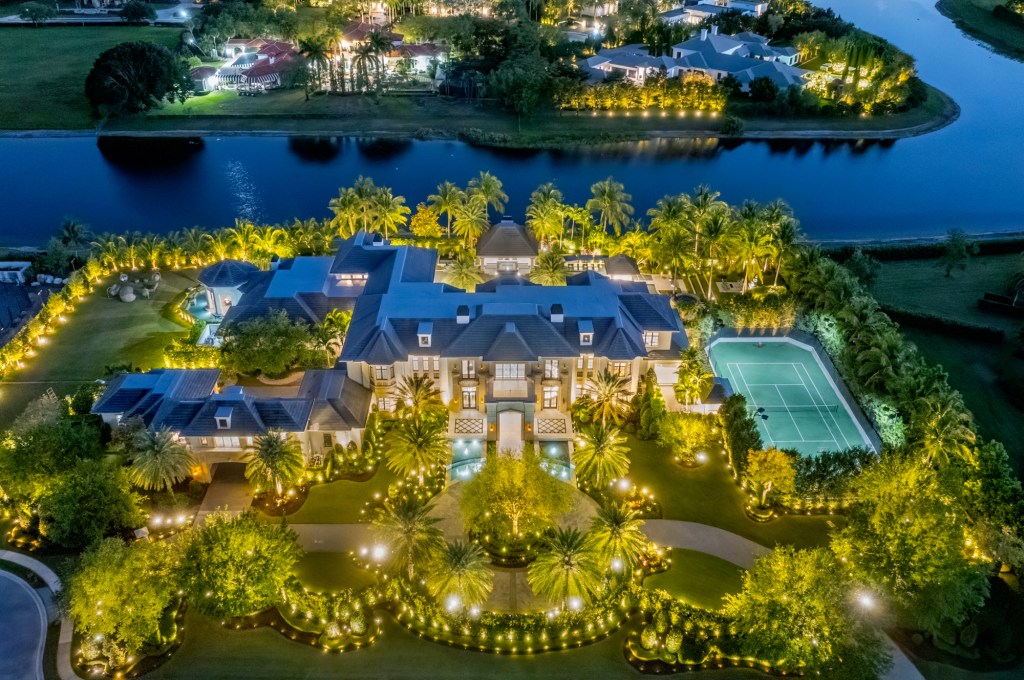 Aerial photo of Mark Wahlberg's new mansion, which sits on a lake and has a tennis court on the right of the property.