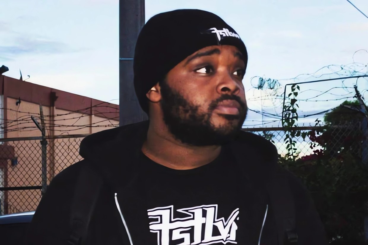 Picture of a man wearing a beanie looking away from the camera.