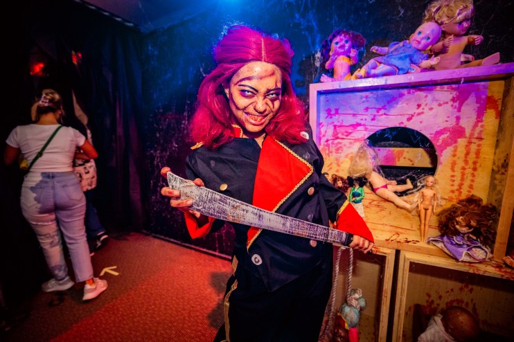 a woman in a red wig, and Halloween mask with dirty teeth
