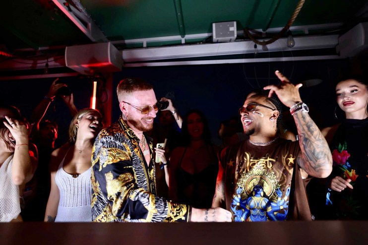 French DJ Hugel behind a DJ booth with Puerto Rican singer Ozuna