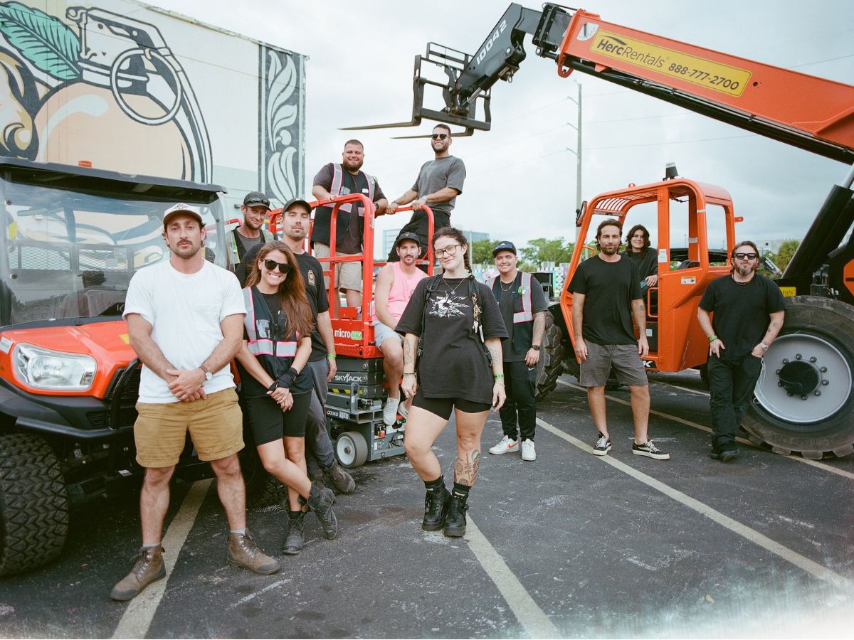 A group of people working on setting up a festival.