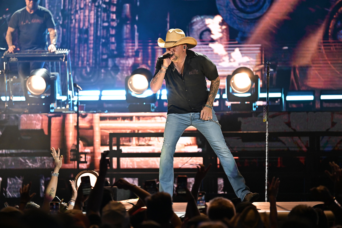 A country singer on stage wearing a country hat.