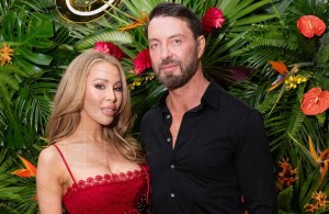Lisa Hochstein poses in a red gown next to Jody Glidden in a black shirt and pants