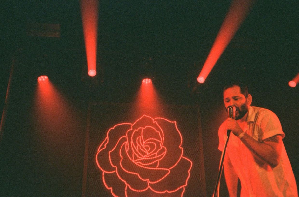 picture of a man holding a mic performing on stage