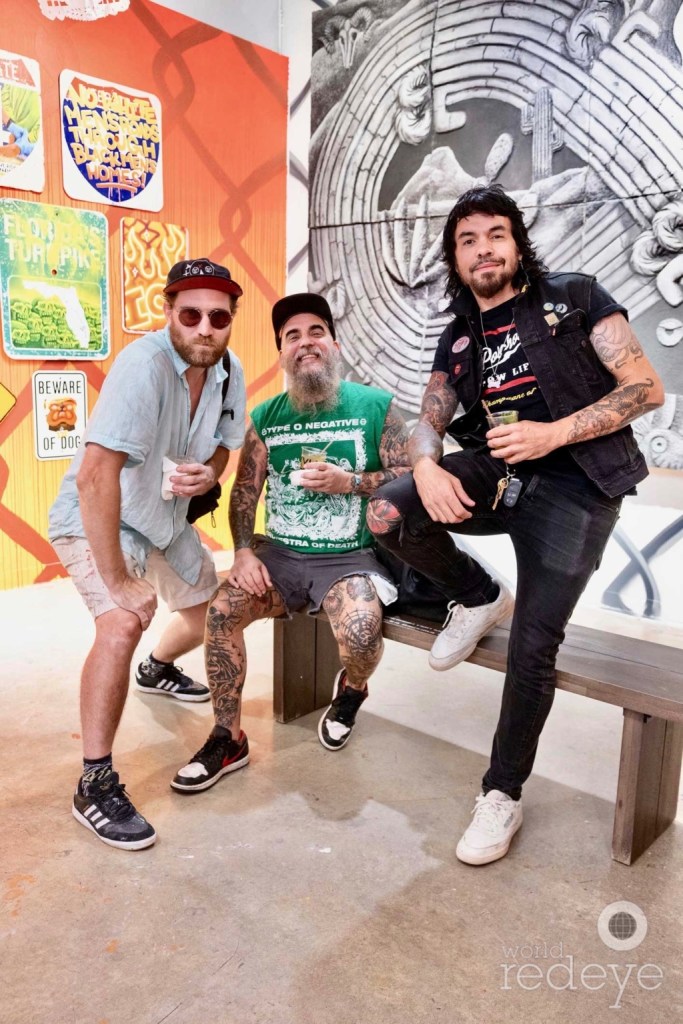 three men dressed like punks pose inside an gallery