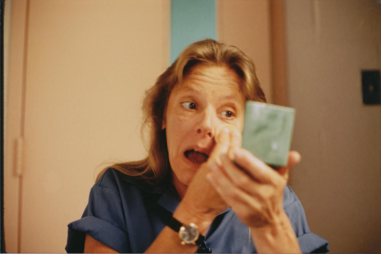 Aileen Wuornos applying powder to her face before an interview behind bars