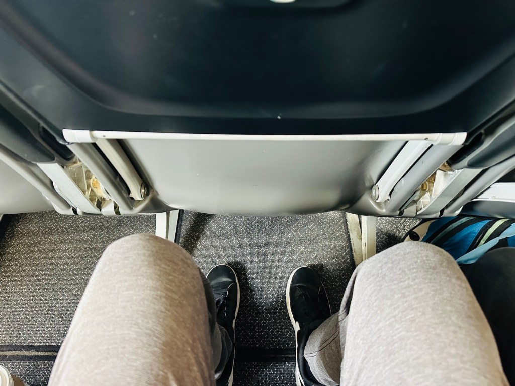 photo of a person's legroom on a plane
