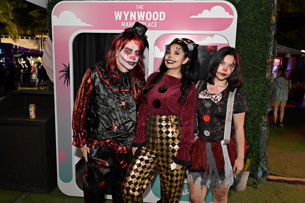 photo of three people dressed as clowns for Halloween
