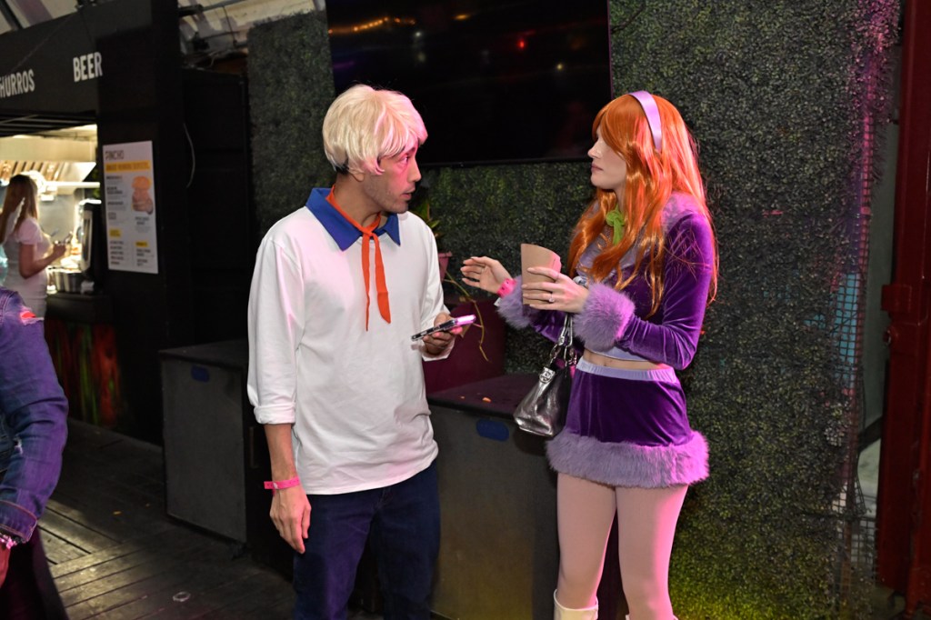 photo of a couple dressed as Daphne Blake and Fred Jones for Halloween
