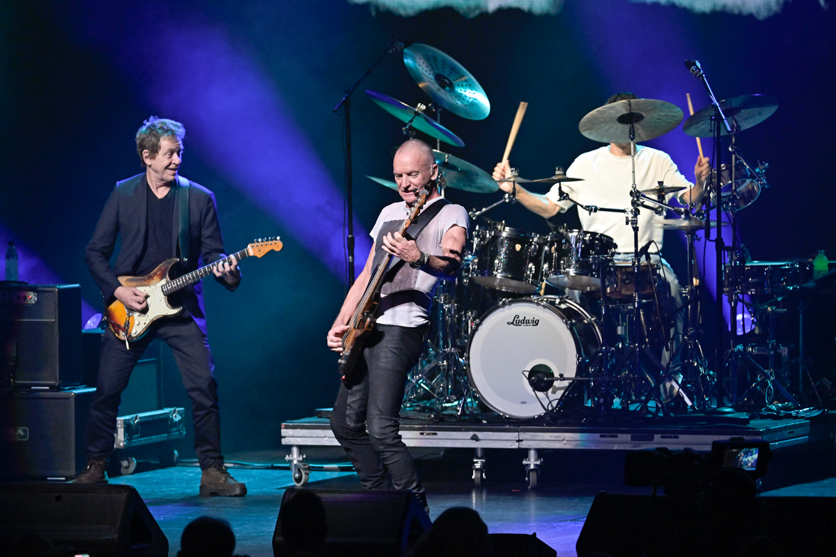 Photo of a rock band performing on stage.