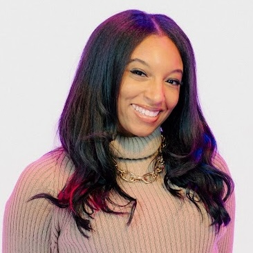 headshot of a smiling, dark-haired young woman