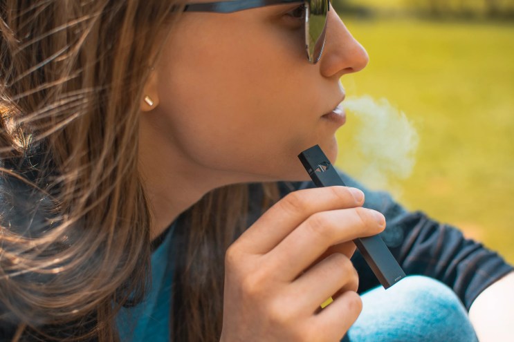 photo of a woman using a vaping device