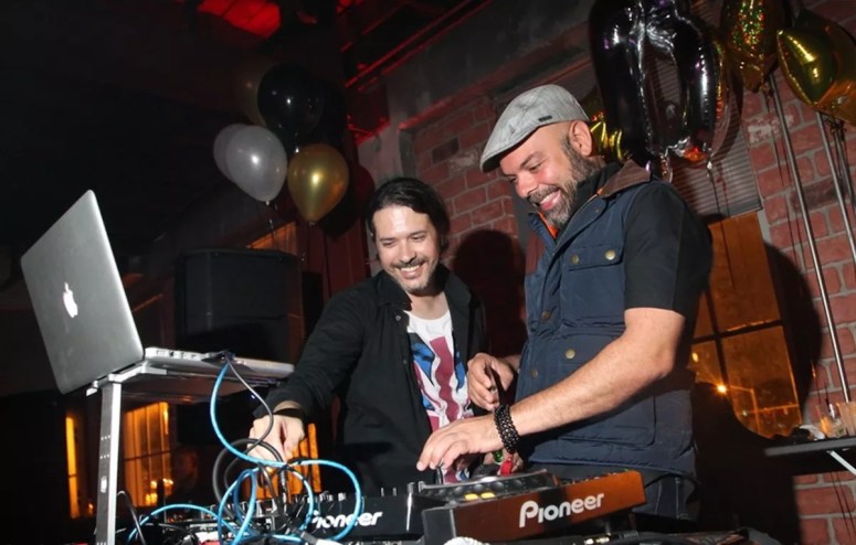 Ray Milian and Aramis Lorie behind the decks at a Poplife party