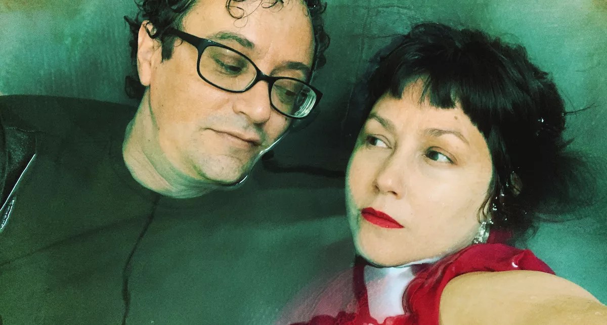 Two people under water with clothes.