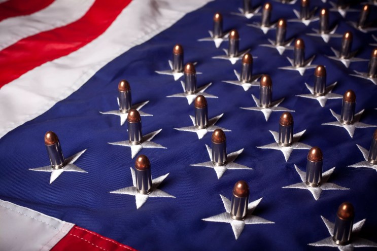 An American flag with bullets placed on each star