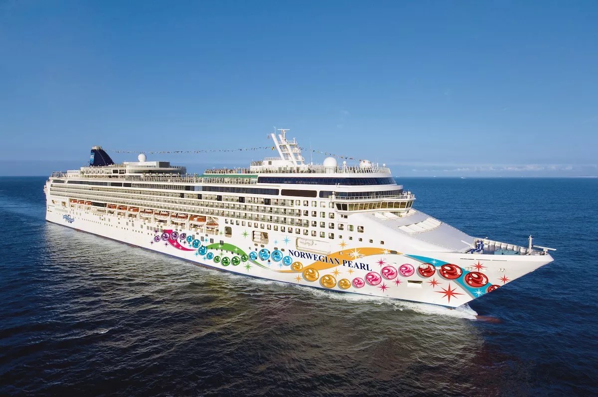 A Norwegian Pearl cruise ship floats across the ocean