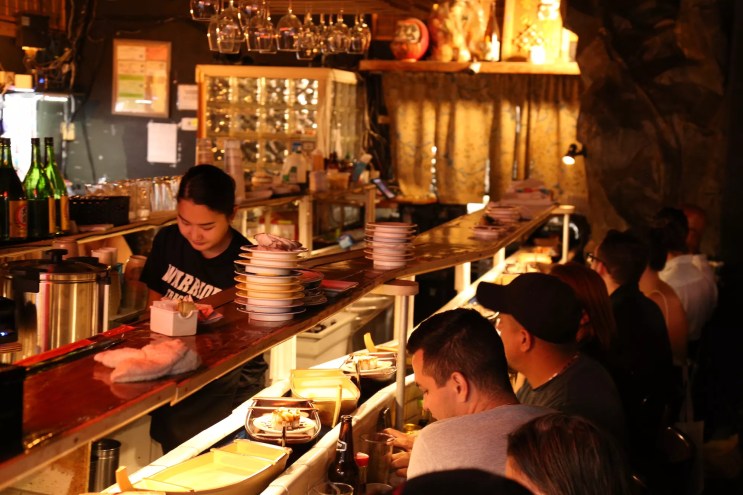 A dimly lit dining room with people