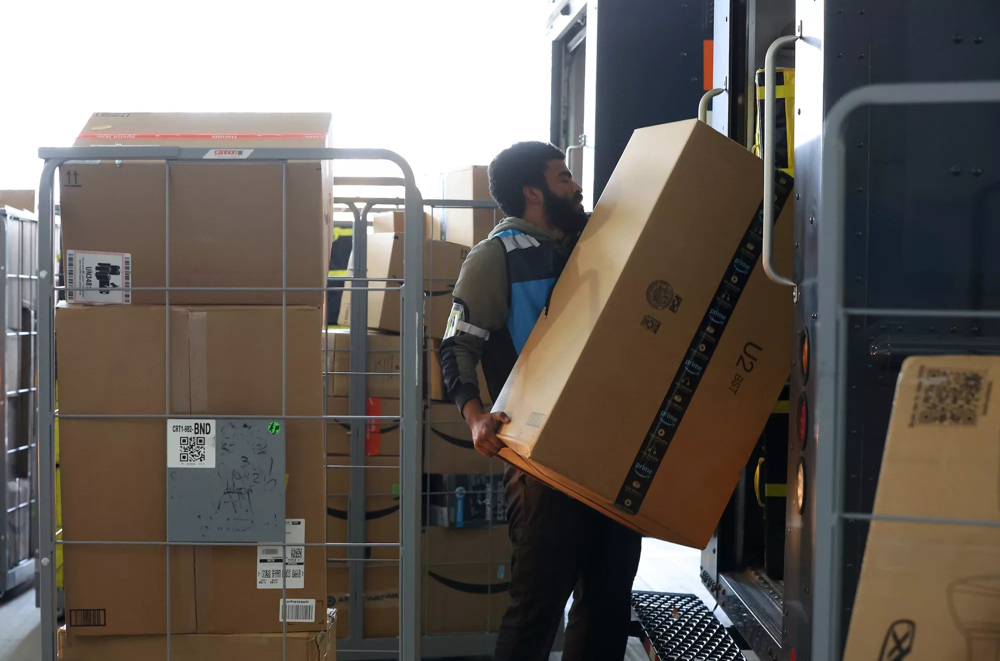 Amazon worker loading packages into delivery van