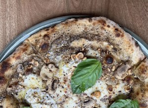 A close-up of a pizza with basil