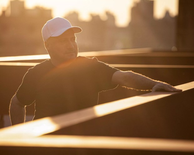 DJ Danny Tenaglia stands on a rooftop, basking in the sunlight
