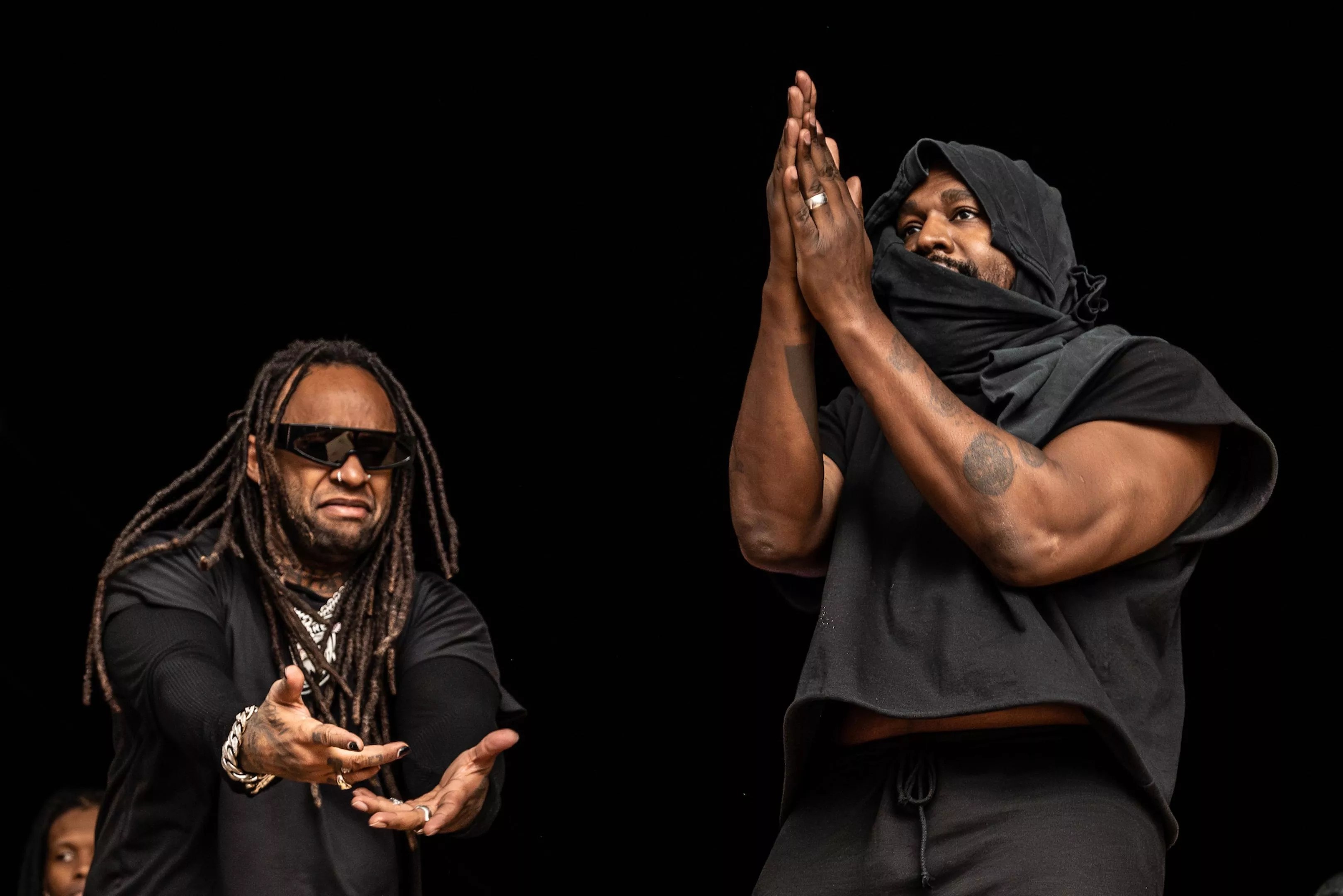 Ty Dolla Sign and a hooded Kanye West on stage at the Vultures Rave in Miami