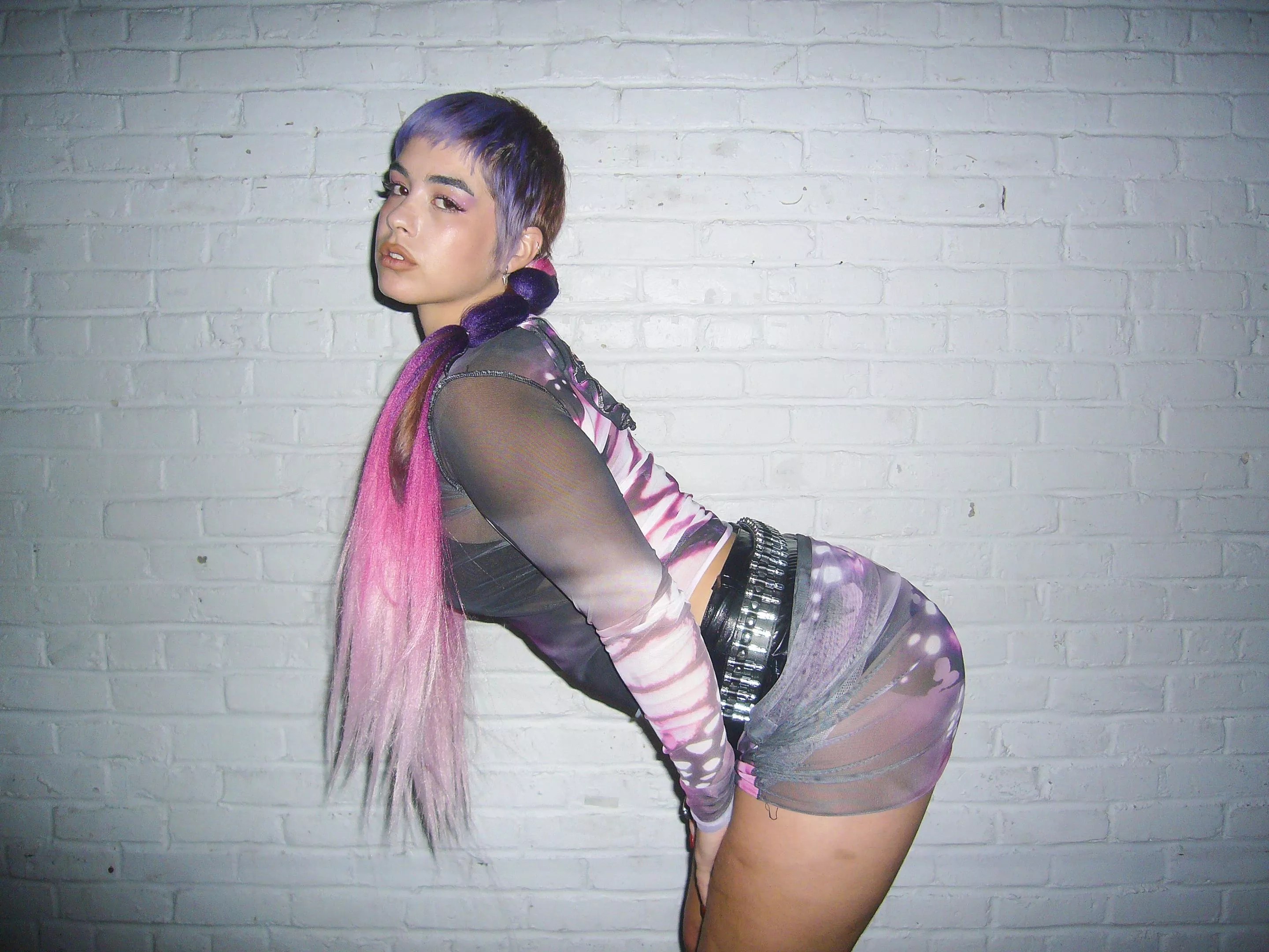 NJ Nebreda leans down while looking at the camera