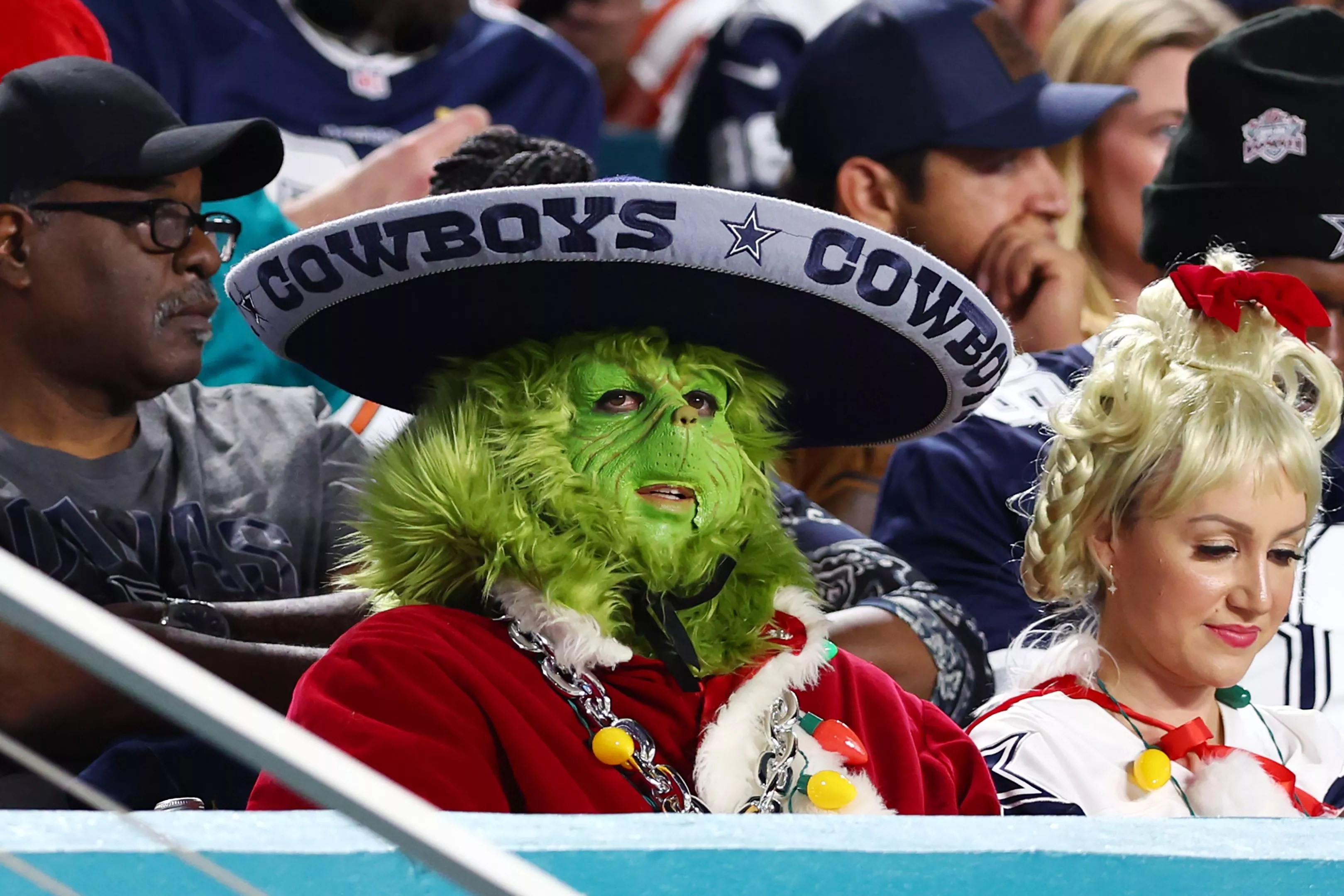 A football fan in an elaborate Grinch costume