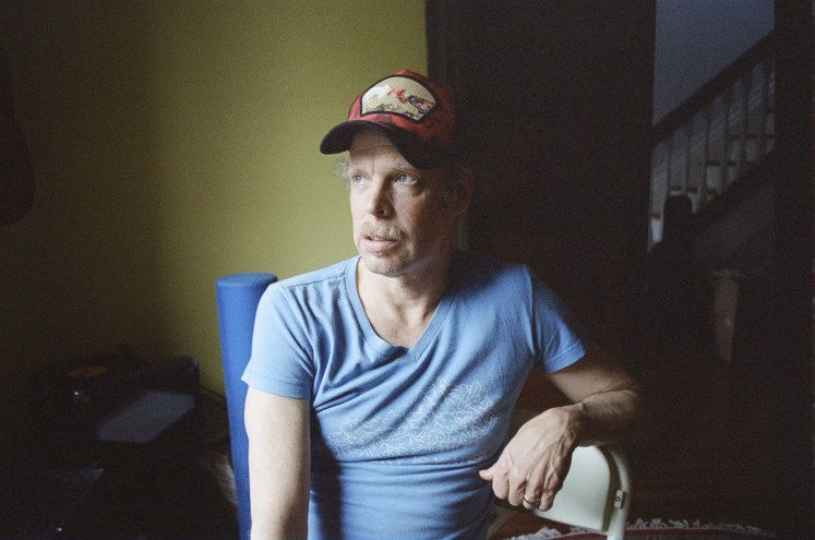 Bonnie "Prince" Billy in a light-blue shirt and baseball cap
