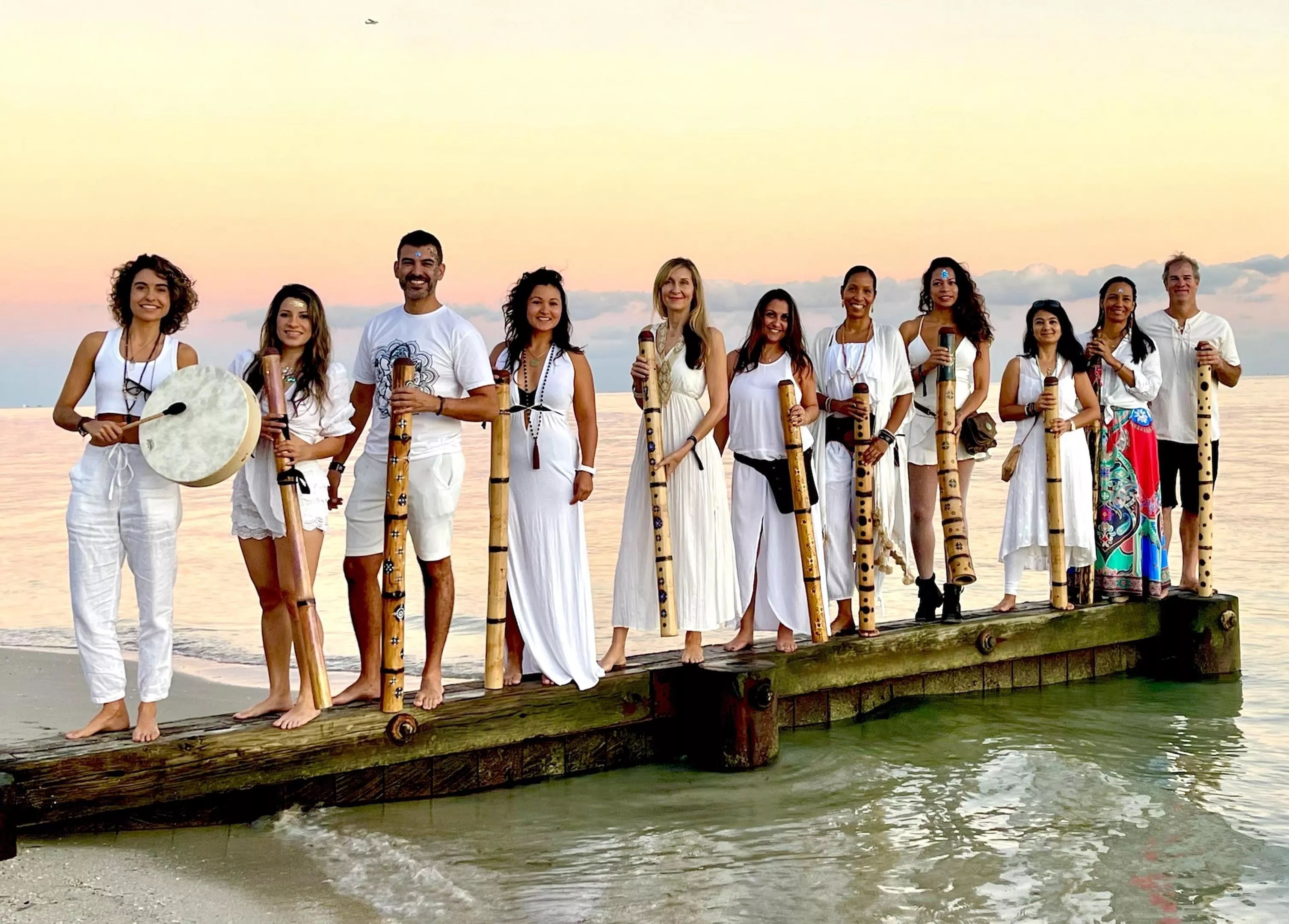 The members of the South Beach Sound Healing Orchestra standing on a dock