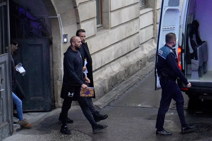 Social media influencer Andrew Tate and his brother walk out of court in Romania