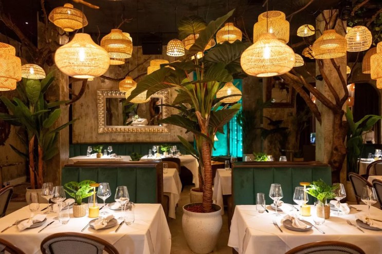 A dining room with chandeliers and wood decor