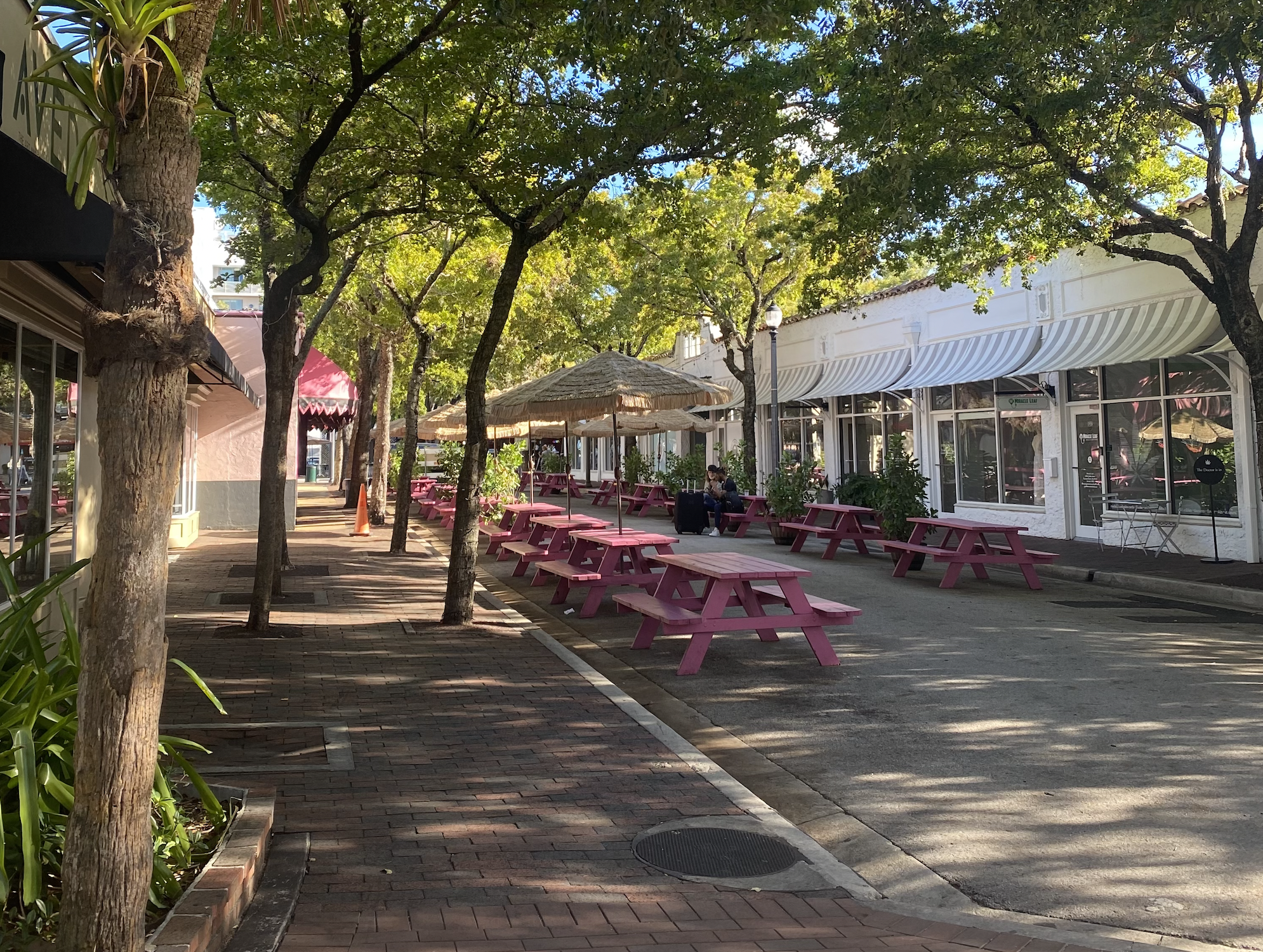An empty street with pink picnic seating