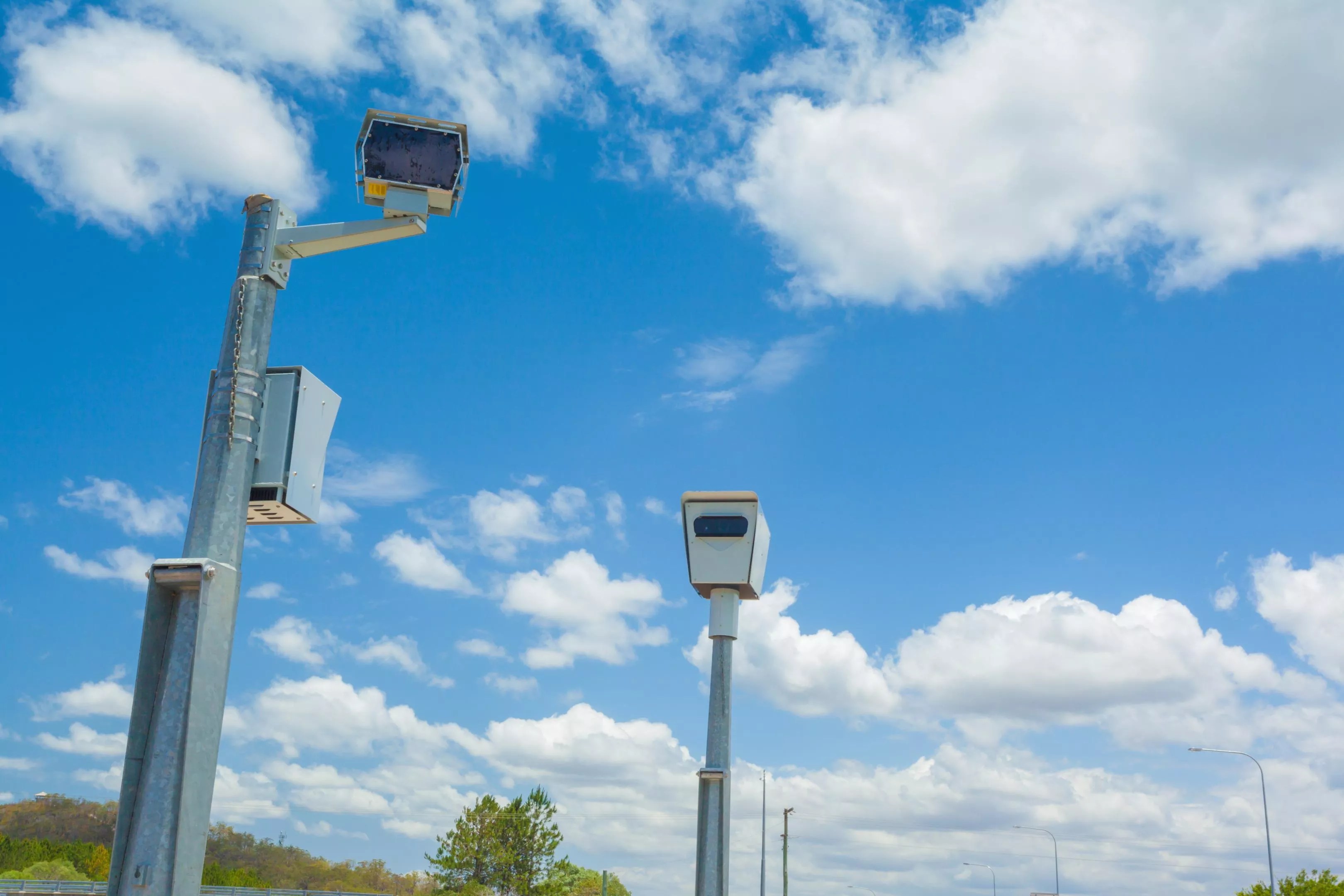 Speed cameras set against a blue sky