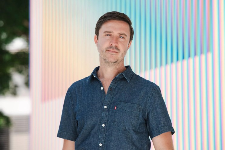 Portrait of James Woolley in a blue button-up shirt