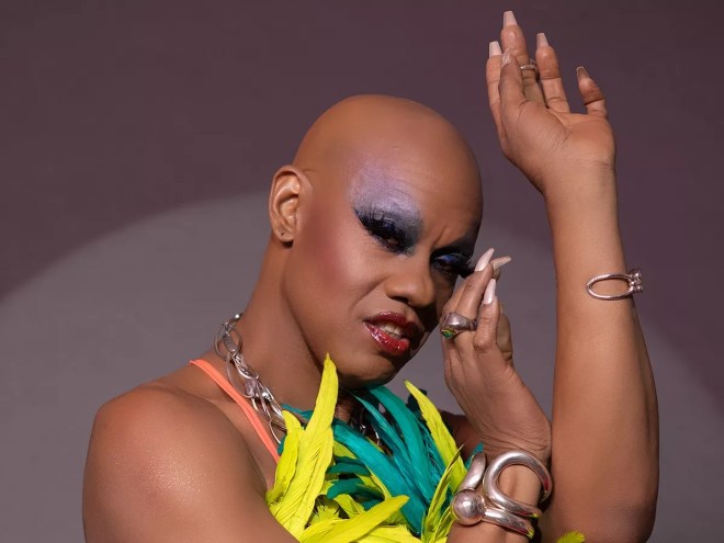 Portrait of Kevin Aviance with heavy makeup and long nails
