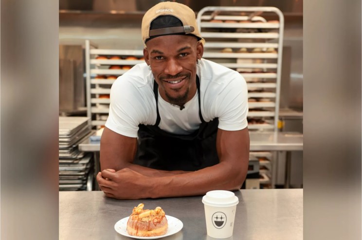 A man posing with a doughnut
