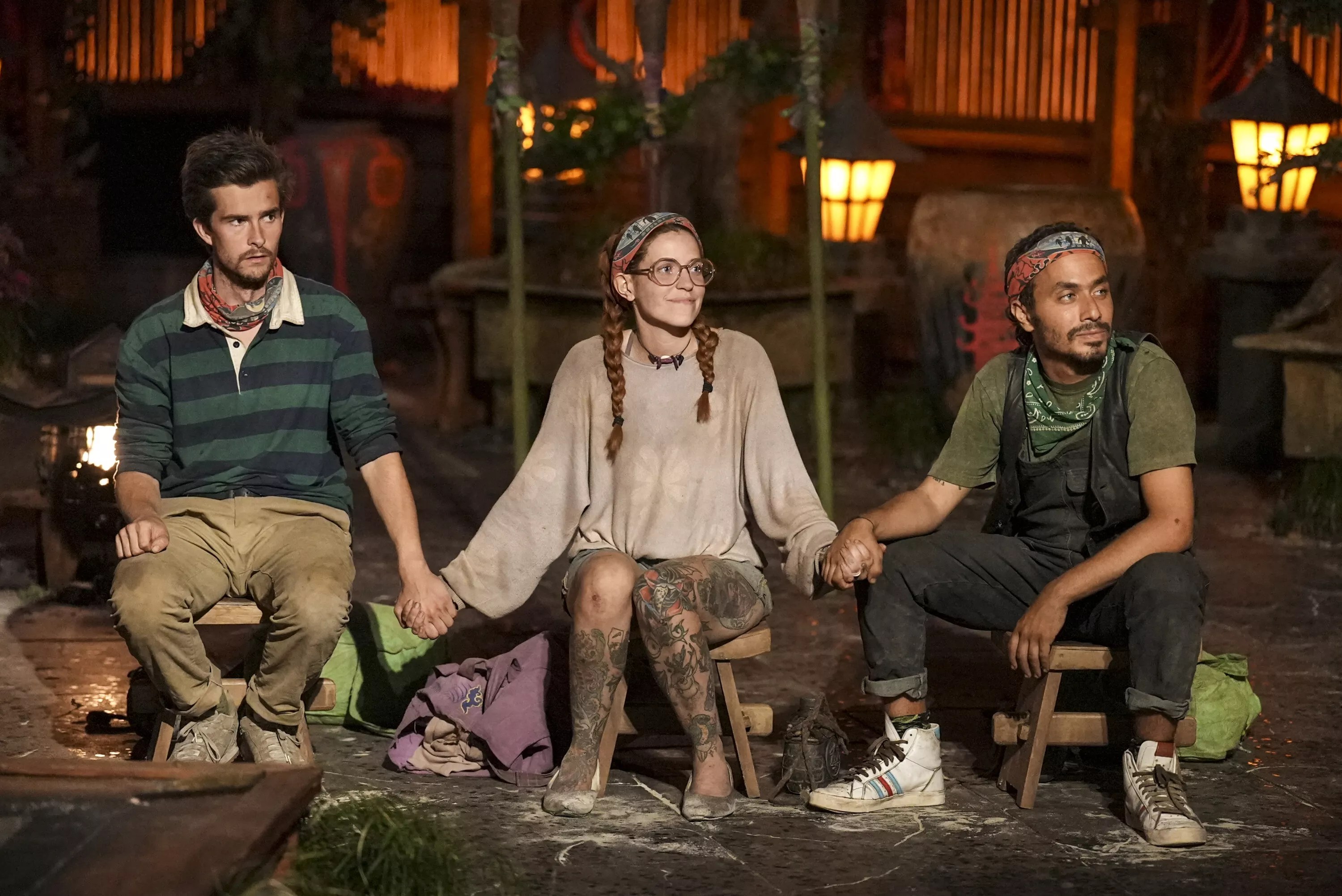 Charlie Davis, Kenzie Petty, and Ben Katzman holding hands during the final ceremony of Survivor 46