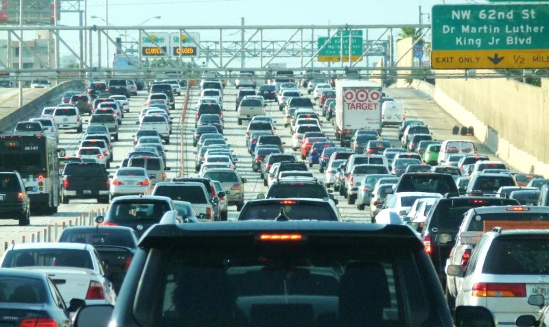 cars cars cars on an urban stretch of interstate, as far as the eye can see