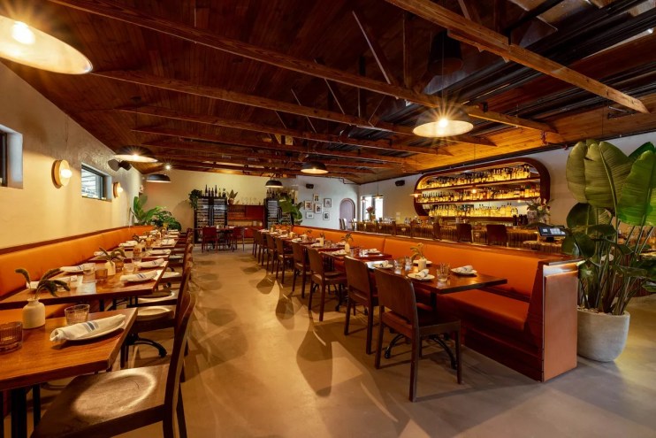 a large dining room with wood chairs