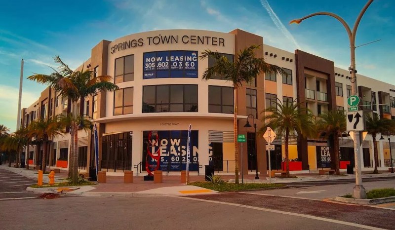 The front entrance to a newly built, modern-look mixed-use in Miami Springs