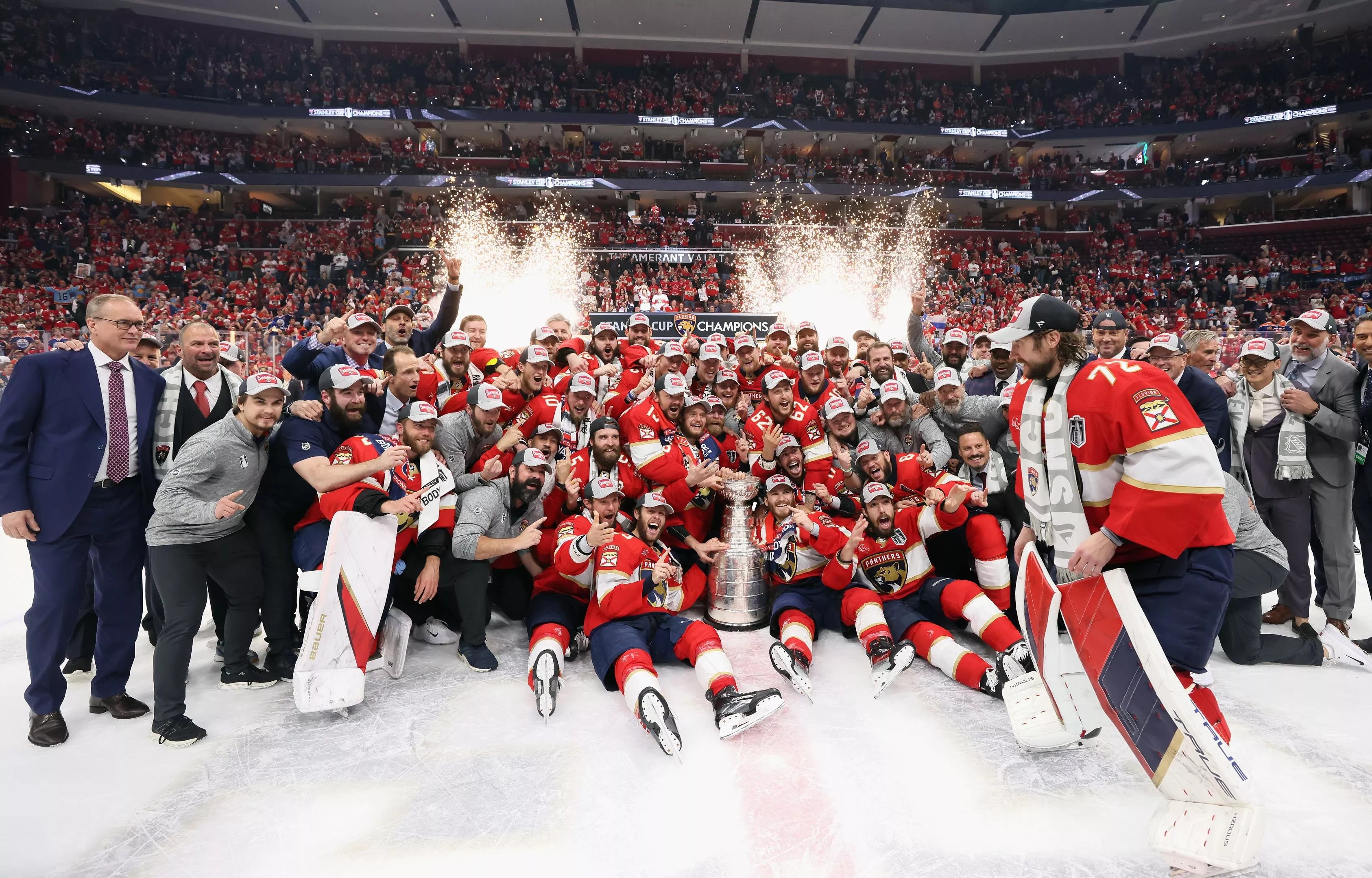 The Florida Panthers gather on the ice to celebrate and pose for a team photo after winning their first championship